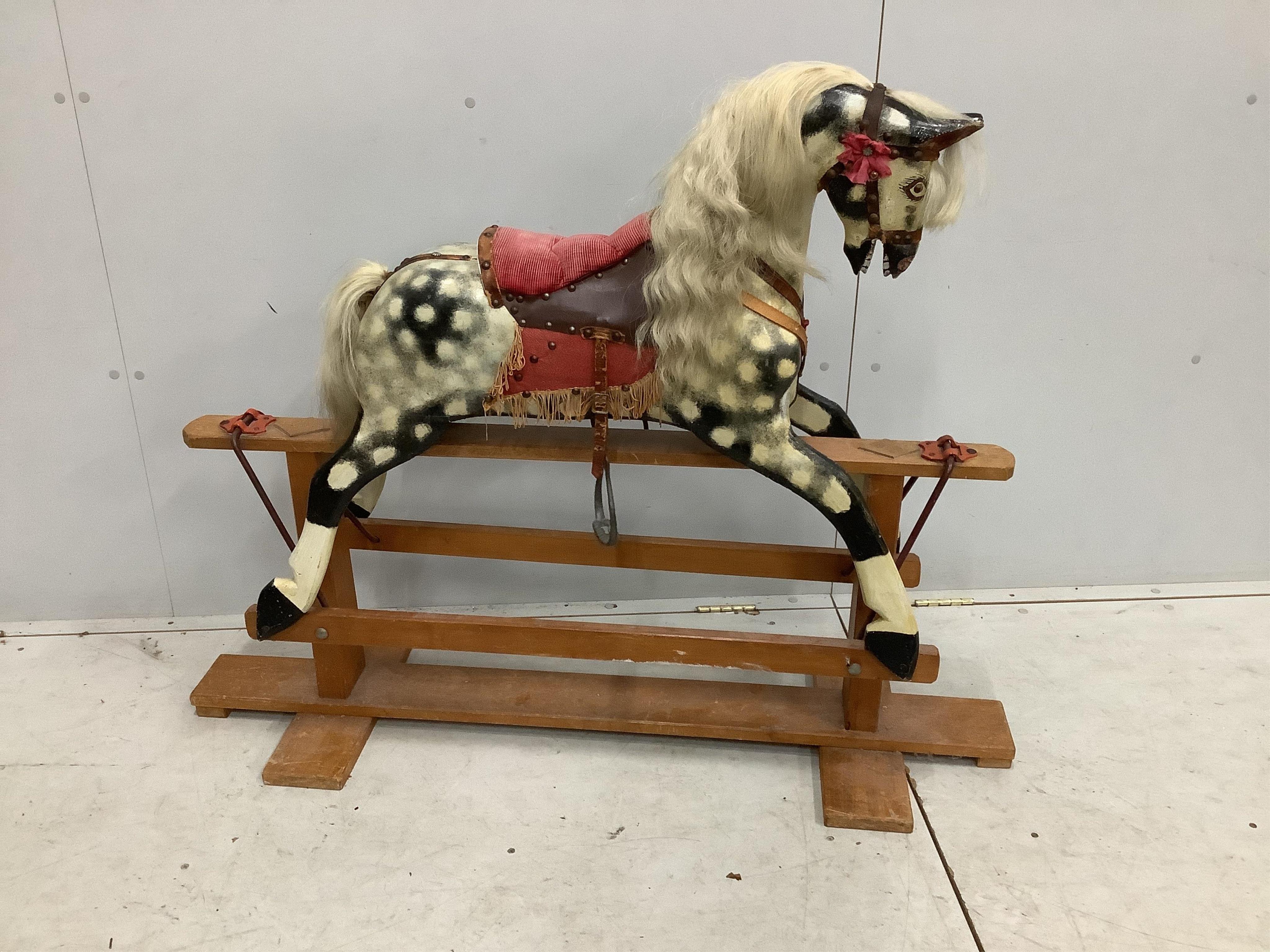 A dapple grey rocking horse, on beech safety frame, length 127cm, height 100cm. Condition - fair